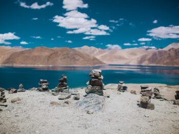 rock formation near calm body of water during daytime