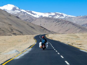 man riding motorcycle on road during daytime